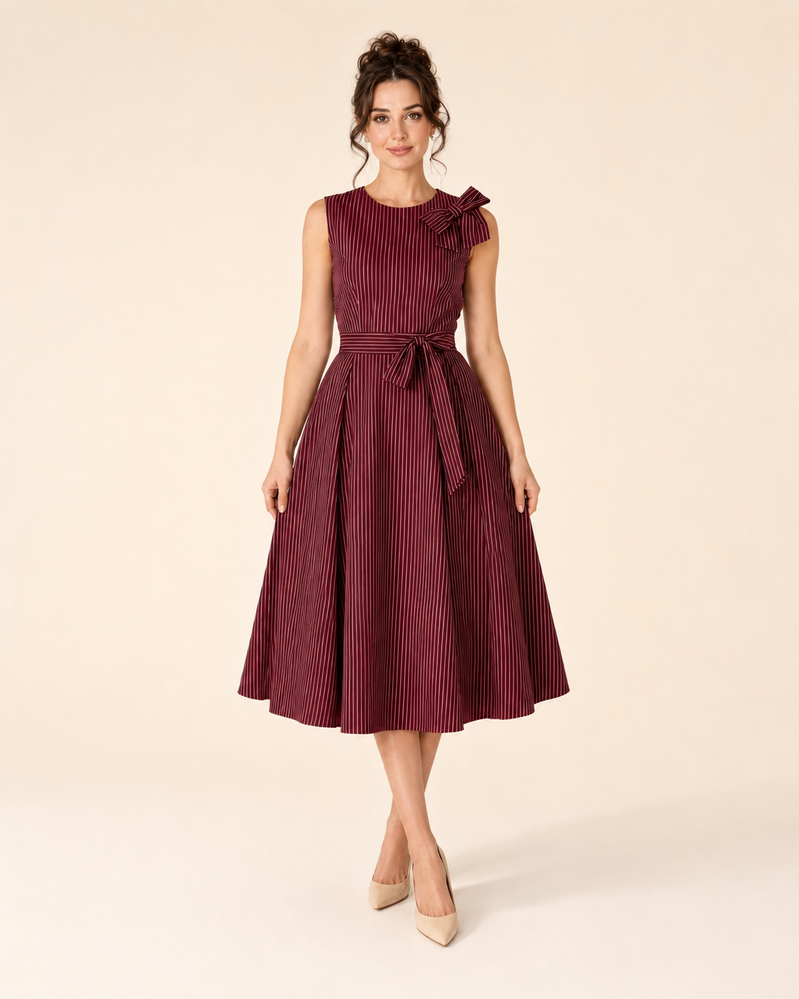 Front view of burgundy sleeveless striped midi dress with waist tie and full skirt