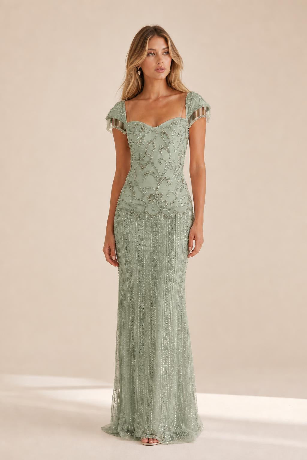 Front view of the sage beaded evening gown