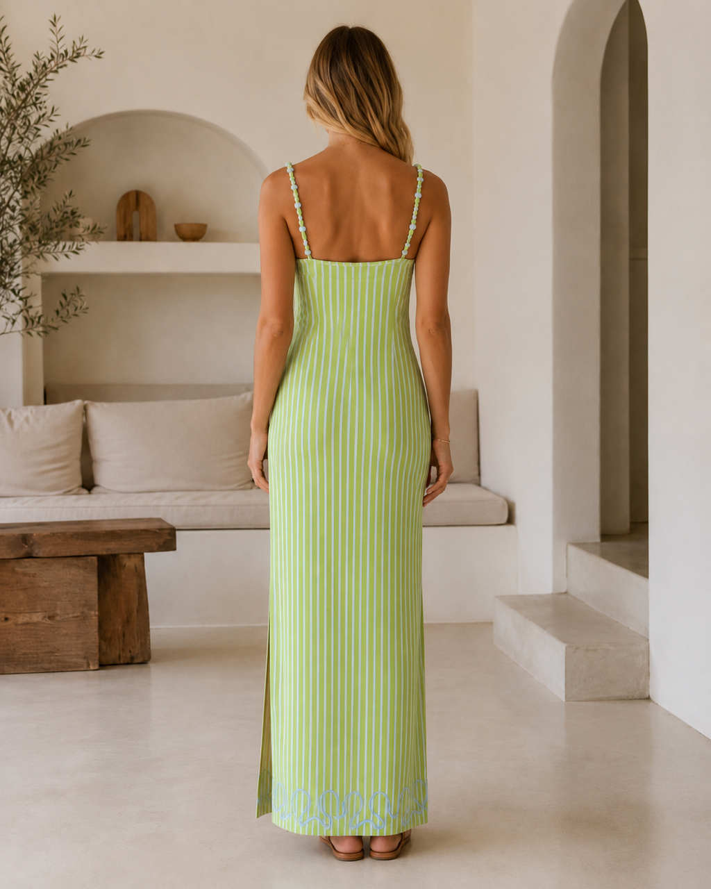 Back view of lime green striped maxi dress with slim straps