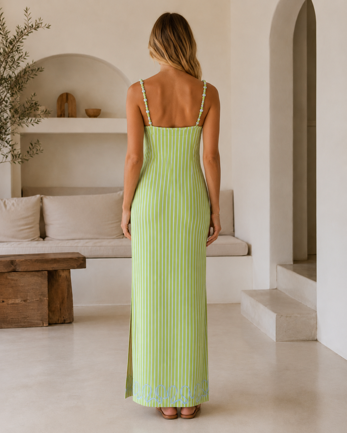 Back view of lime green striped maxi dress with slim straps