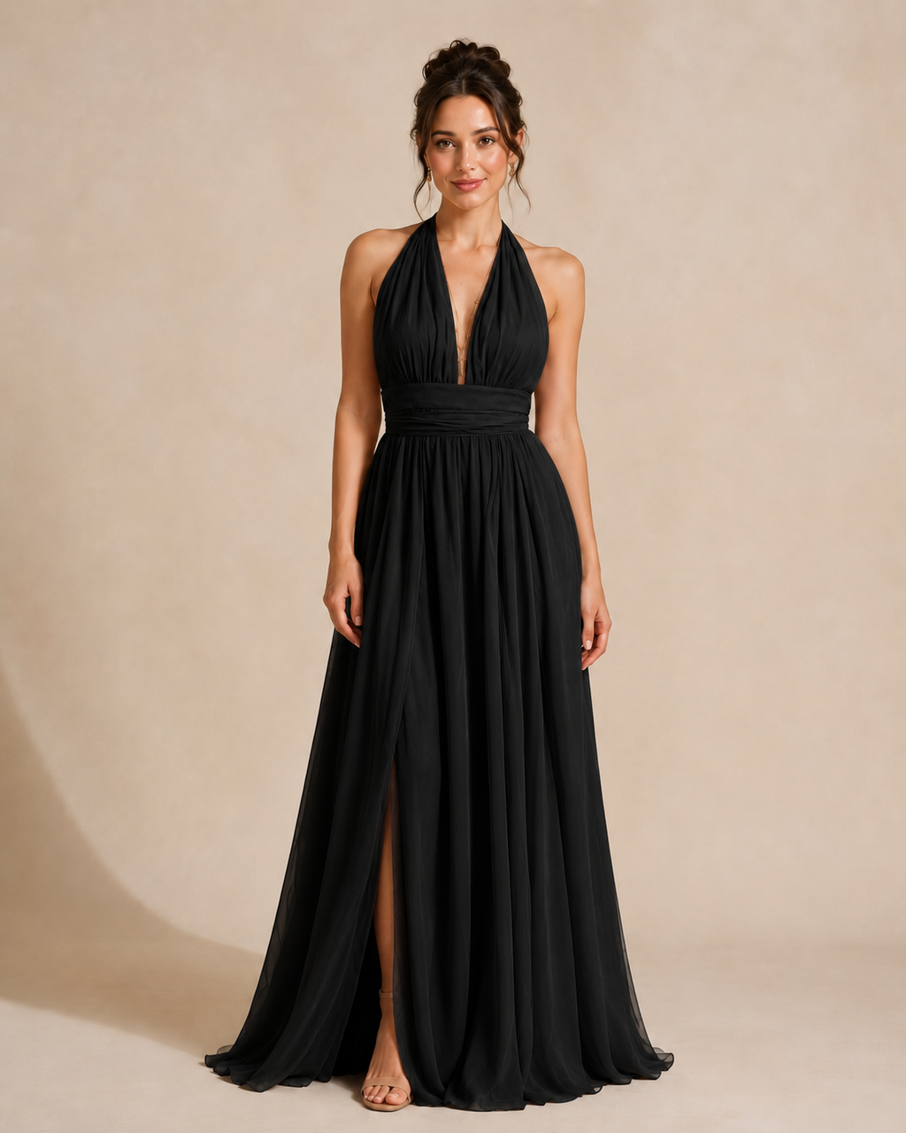 Full-length front view of black halter maxi dress with gathered waistband and front slit