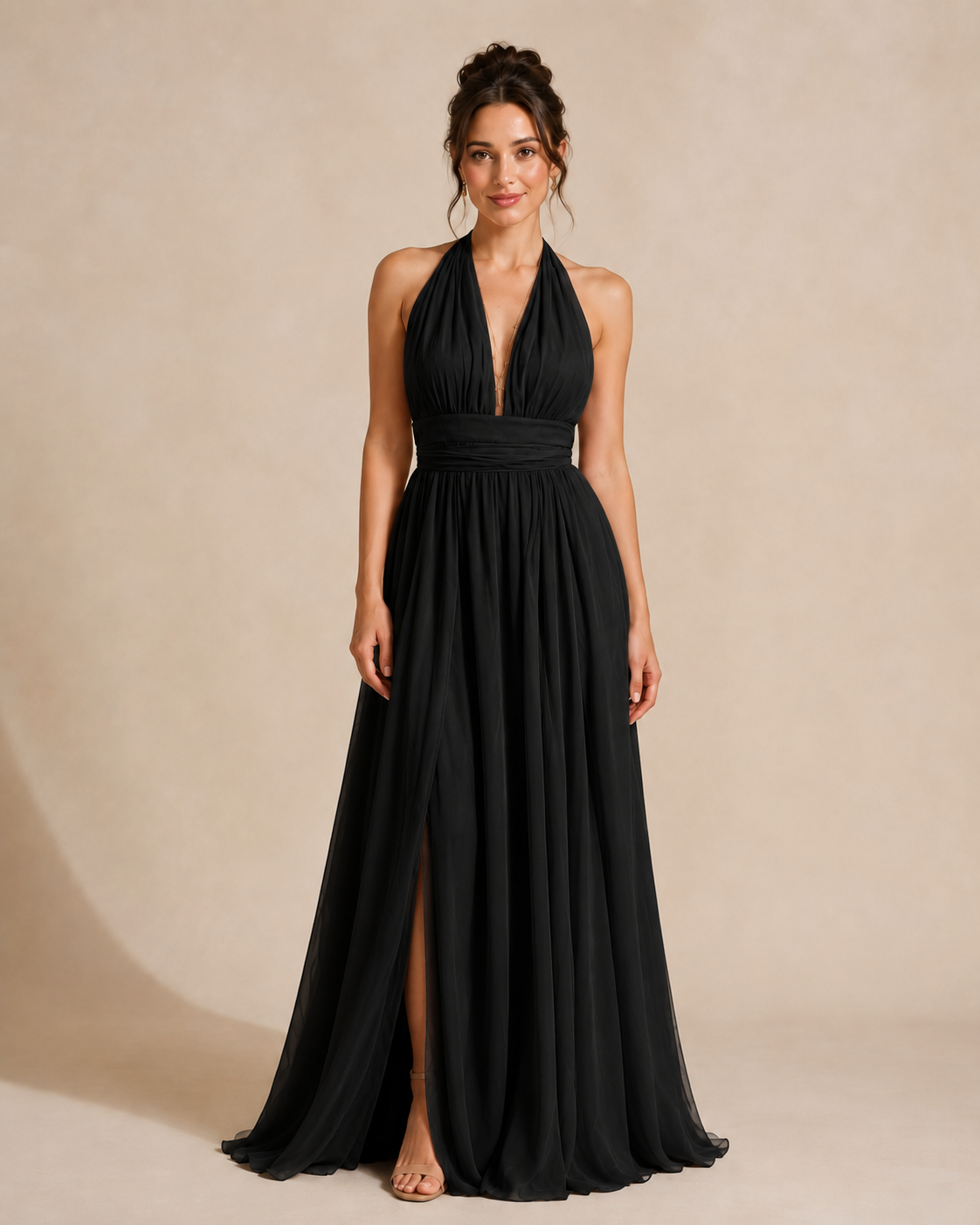 Full-length front view of black halter maxi dress with gathered waistband and front slit