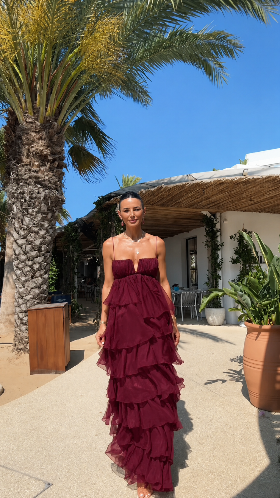 Front view of strapless tiered ruffle maxi dress in burgundy