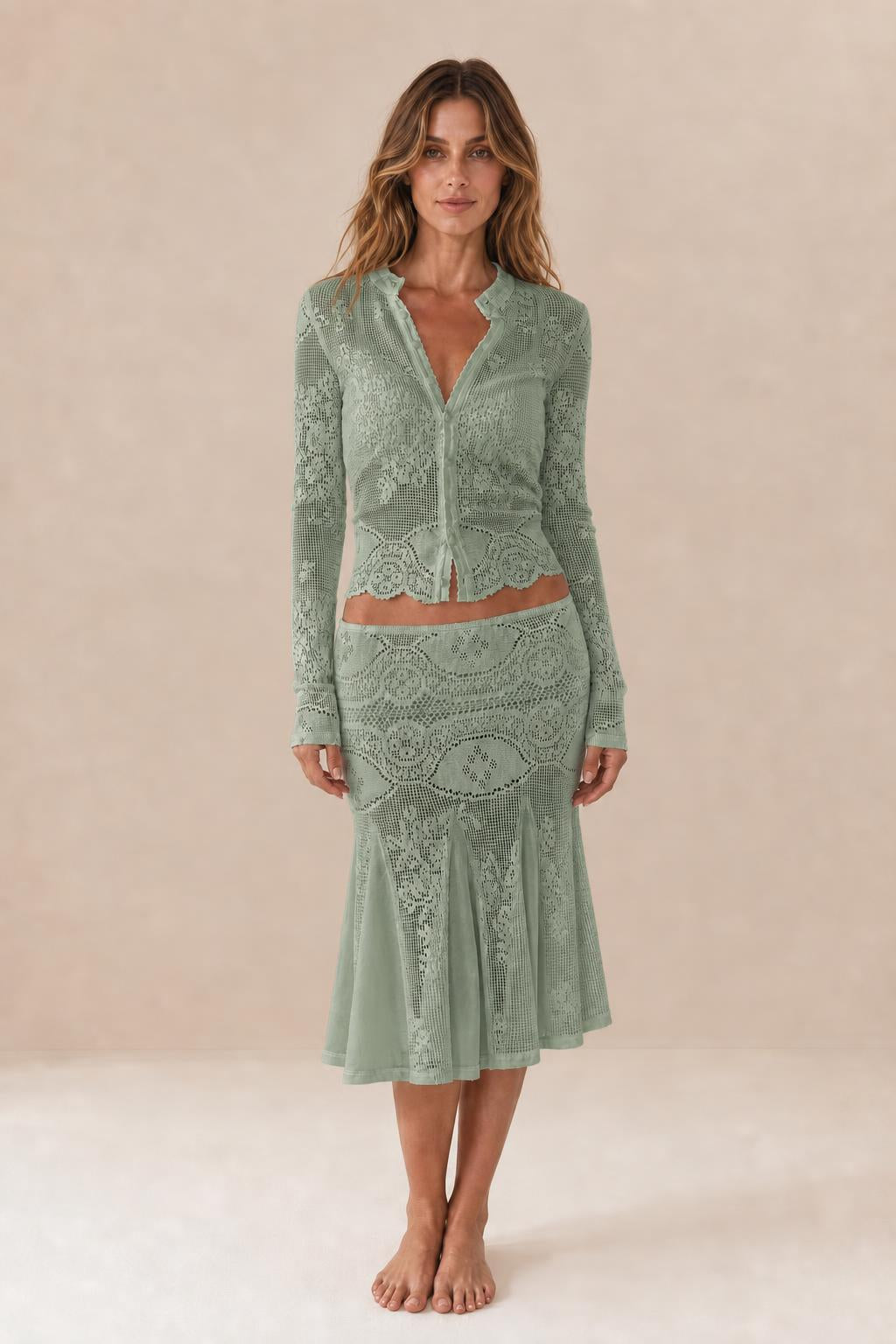 Front view of woman wearing sage green crochet lace two-piece set