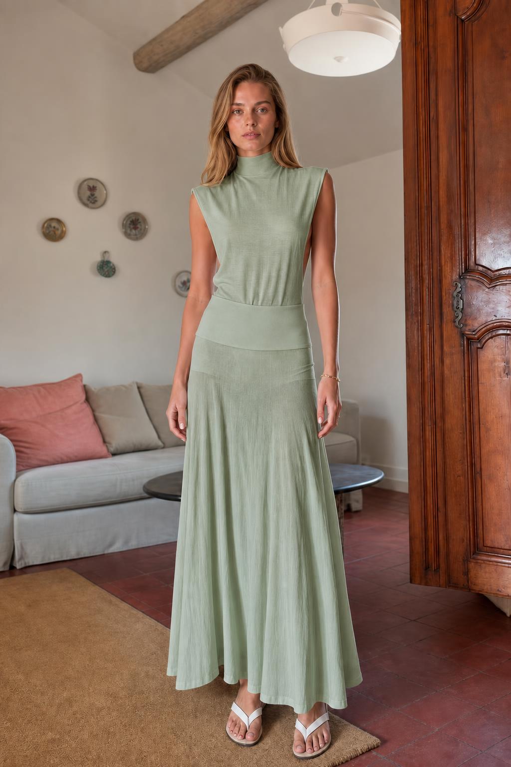 Model wearing sage green sleeveless mock neck knit maxi dress