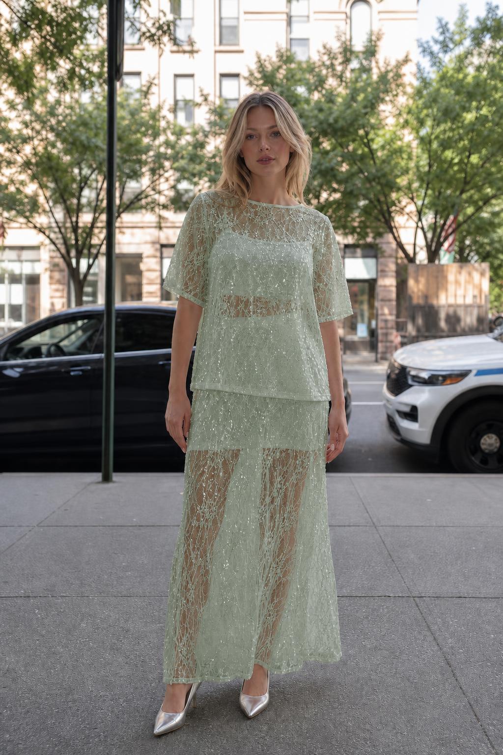 Woman wearing sage green sheer sequin lace two-piece set
