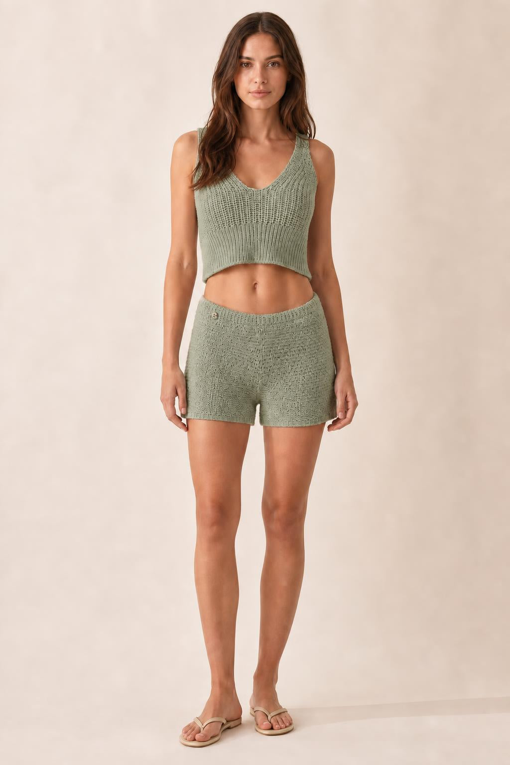 Model wearing sage green ribbed knit crop tank and shorts set