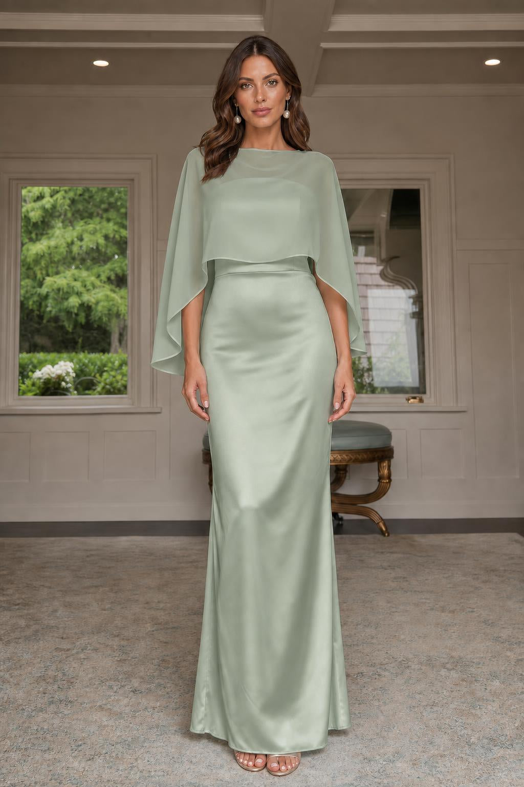 Model wearing sage green cape-overlay evening gown