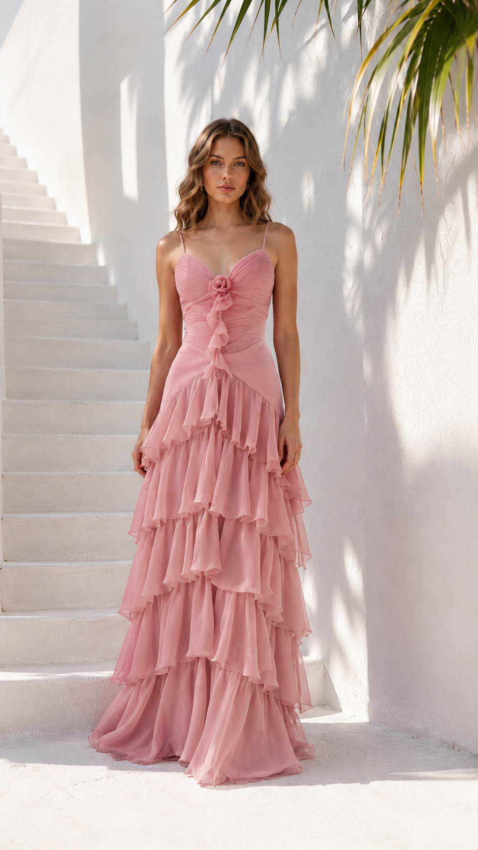 Front view of blush pink layered maxi dress with rosette detail