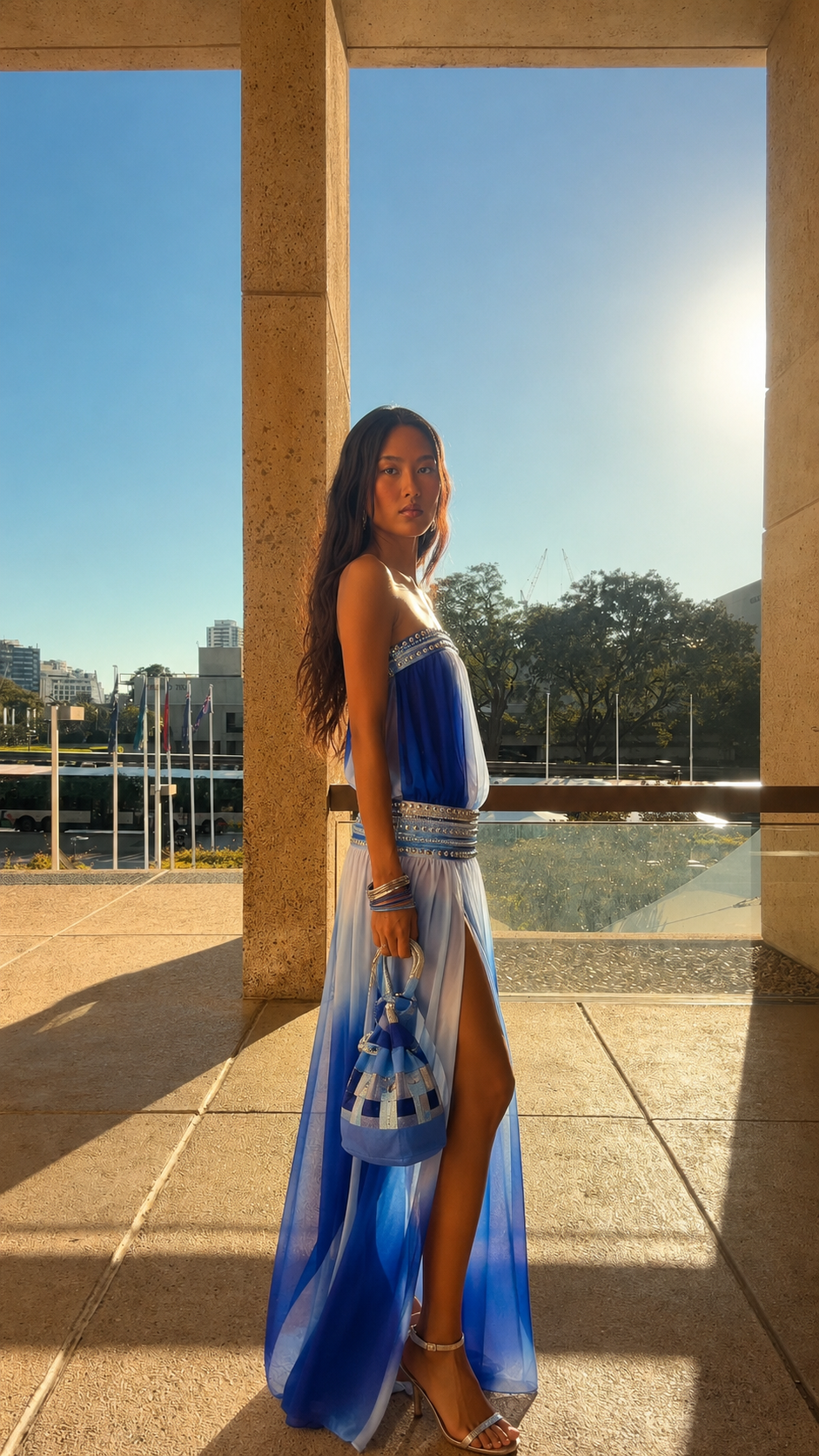 Side view of cobalt blue strapless maxi dress with embellished waist and slit