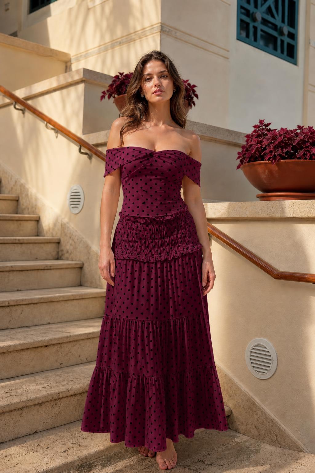 Model wearing burgundy polka dot off-the-shoulder maxi dress