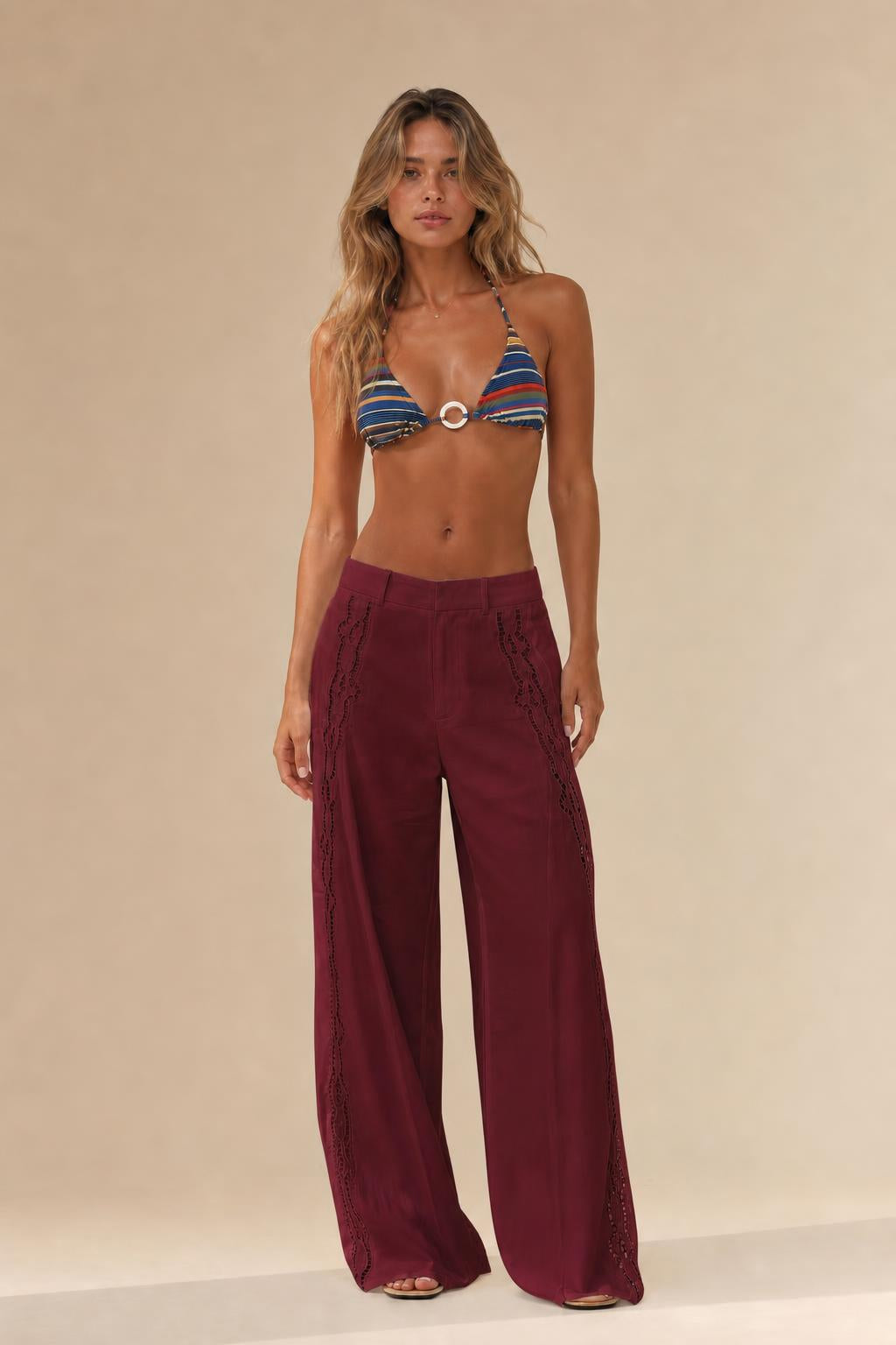 Woman wearing burgundy cutout wide leg trousers