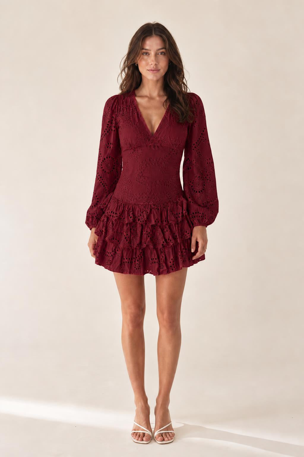 Front view of model wearing burgundy eyelet mini dress