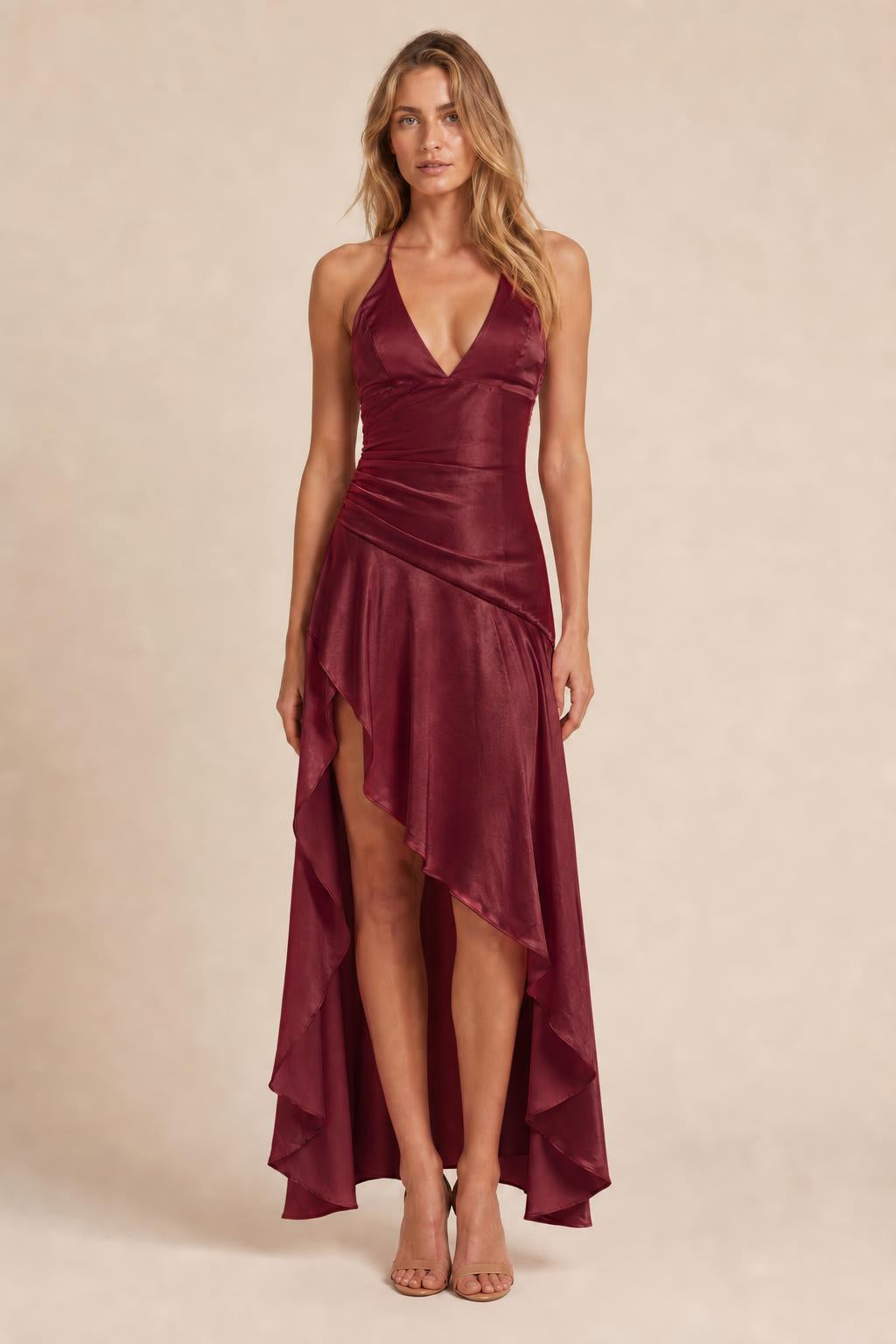 Model wearing burgundy satin halter high-low maxi dress