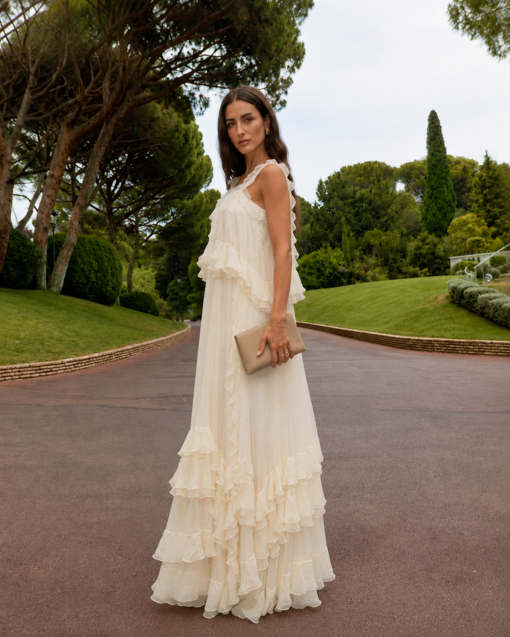 Side view of cream flowing maxi dress with layered ruffle hem
