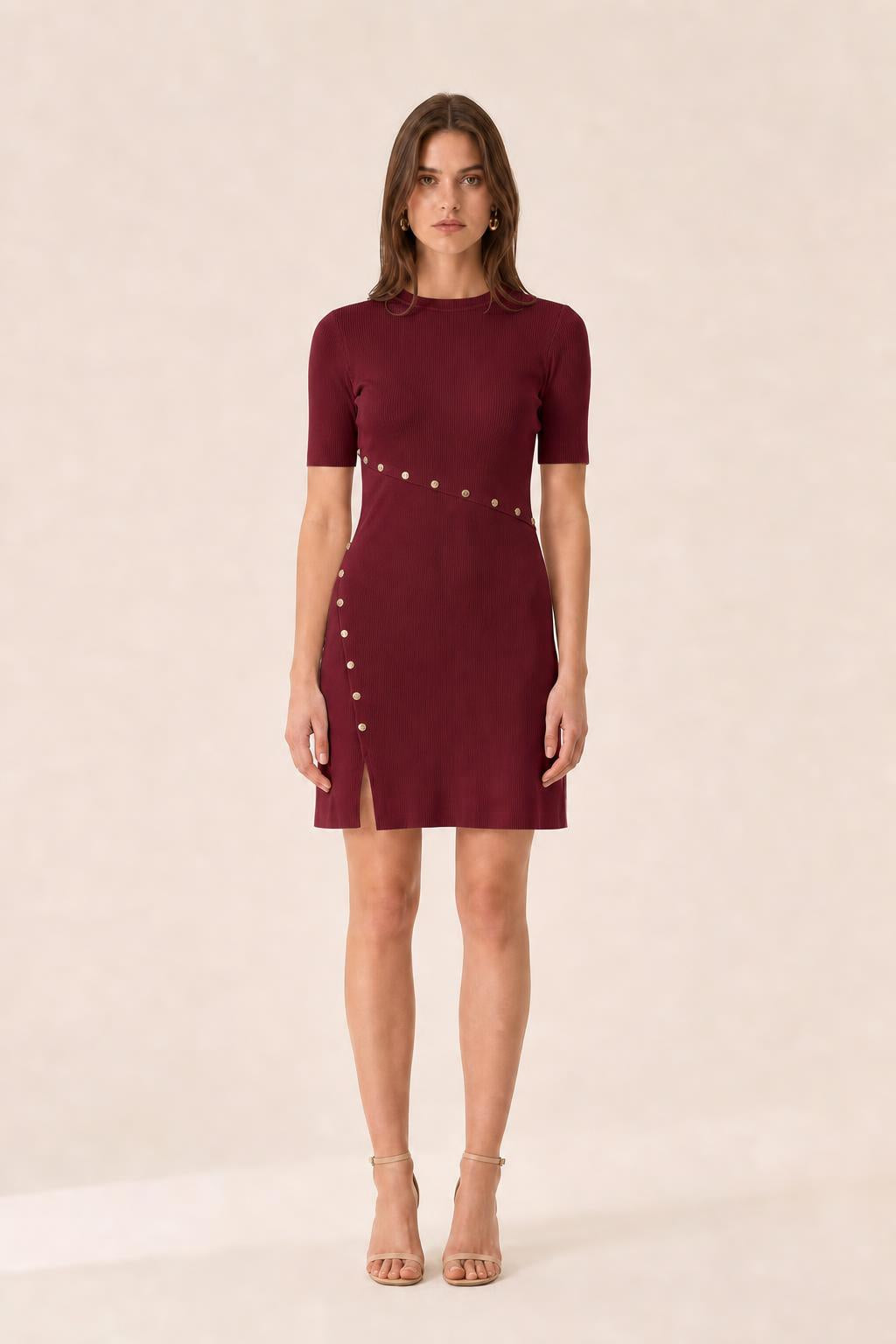 Front view of woman wearing burgundy ribbed knit mini dress