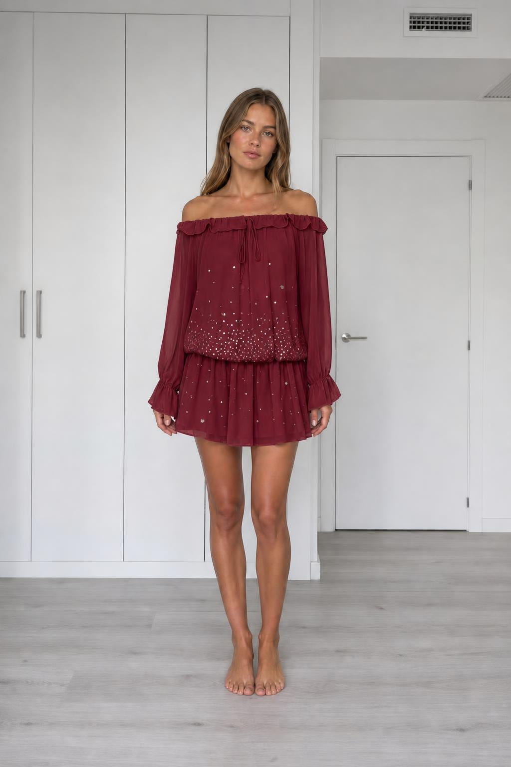 Front view of model wearing burgundy off-the-shoulder chiffon mini dress