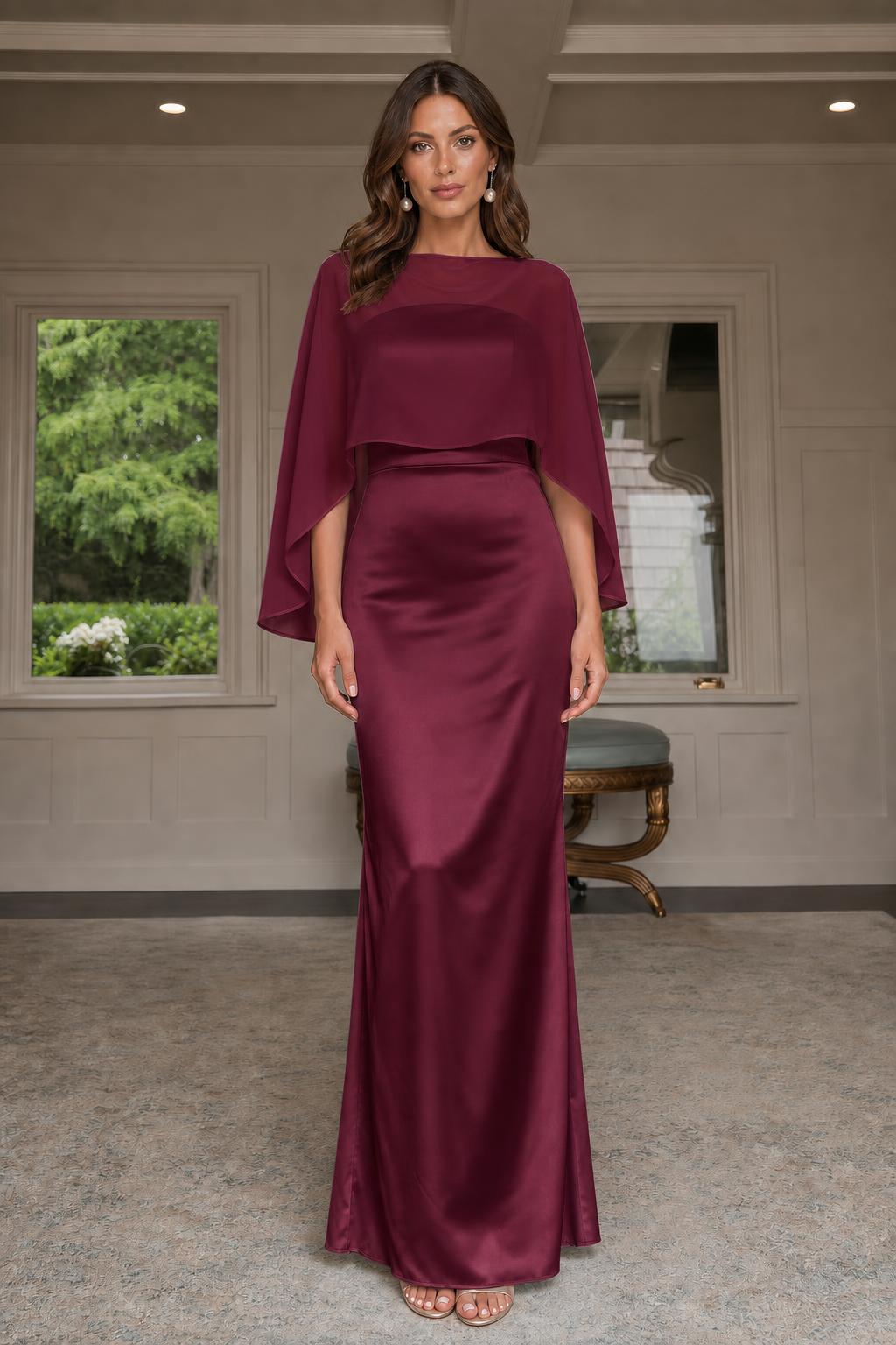 Model wearing burgundy cape-overlay evening gown