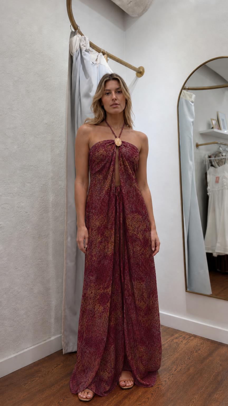 Model wearing burgundy patterned halter maxi dress