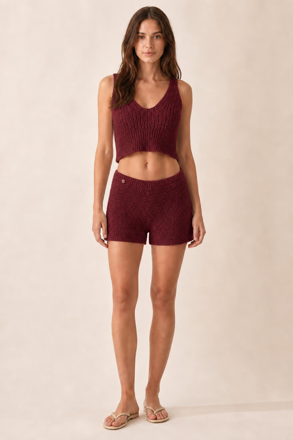 Model wearing burgundy ribbed knit crop tank and shorts set