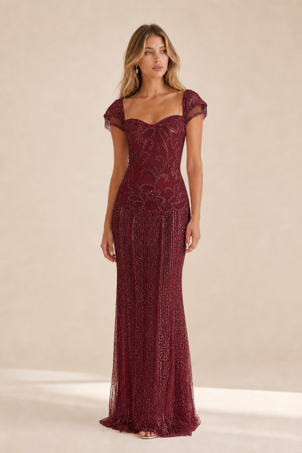 Front view of the burgundy beaded evening gown