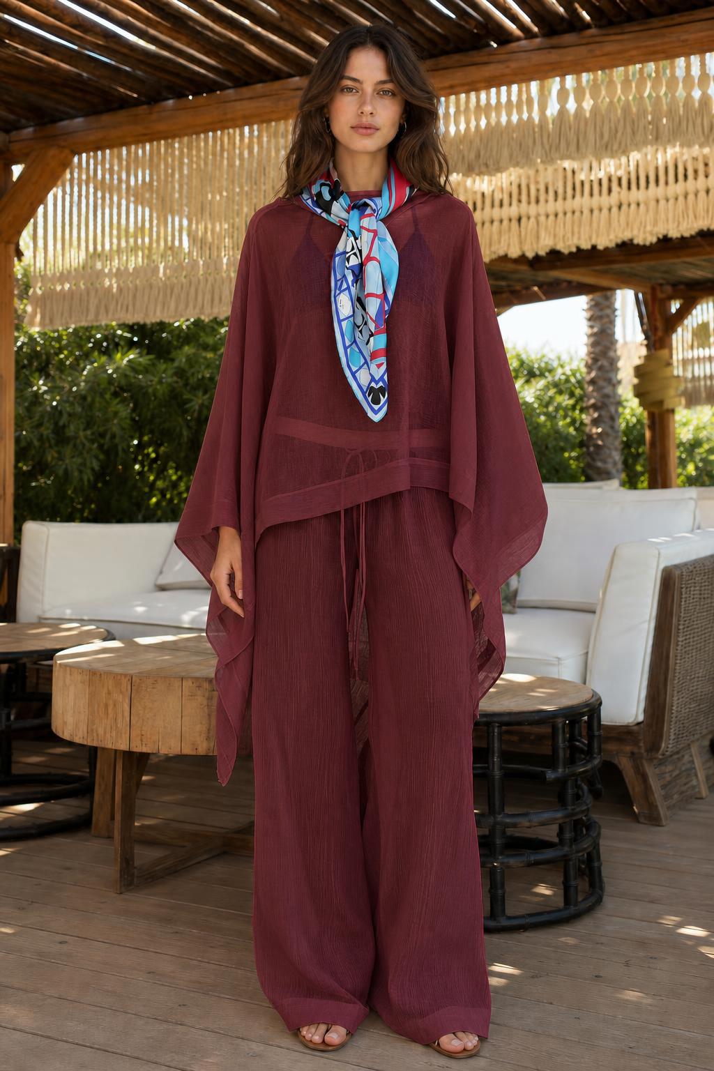 Model wearing deep burgundy two-piece kaftan and wide-leg pants set