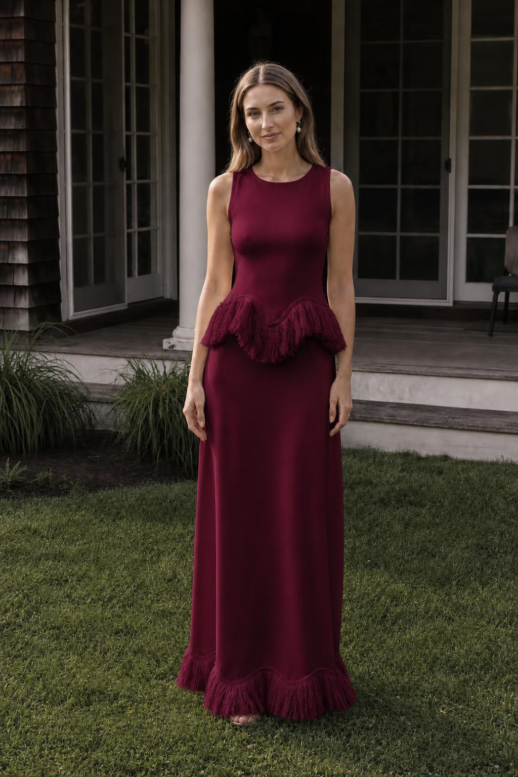 Front view of model wearing burgundy fringed peplum maxi dress