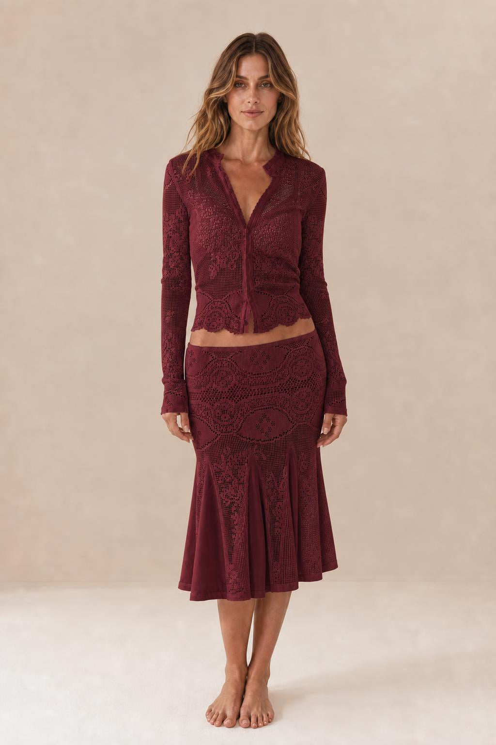 Front view of woman wearing burgundy crochet lace two-piece set
