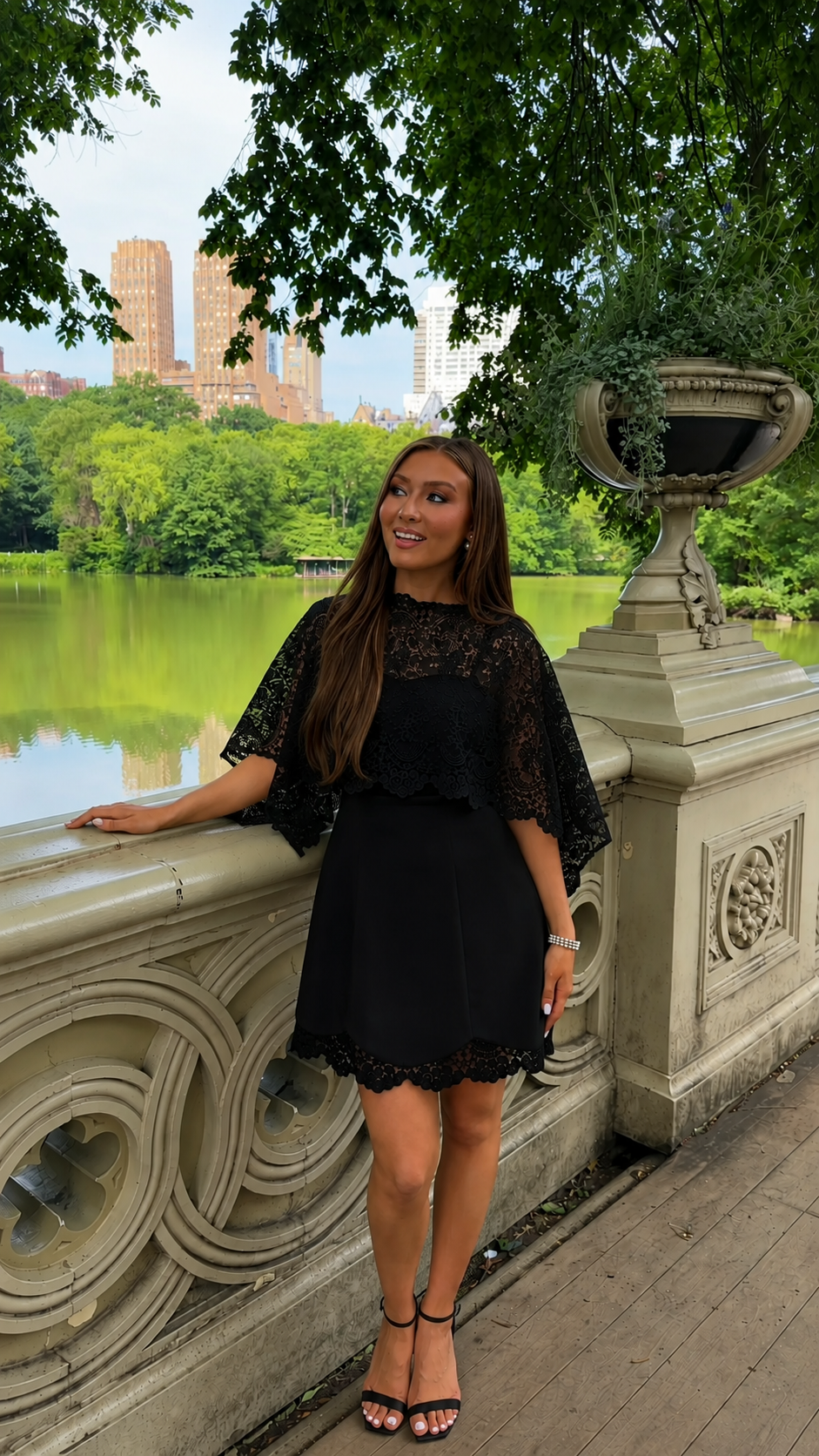 Front view of black lace cape sleeve mini dress with scalloped hem