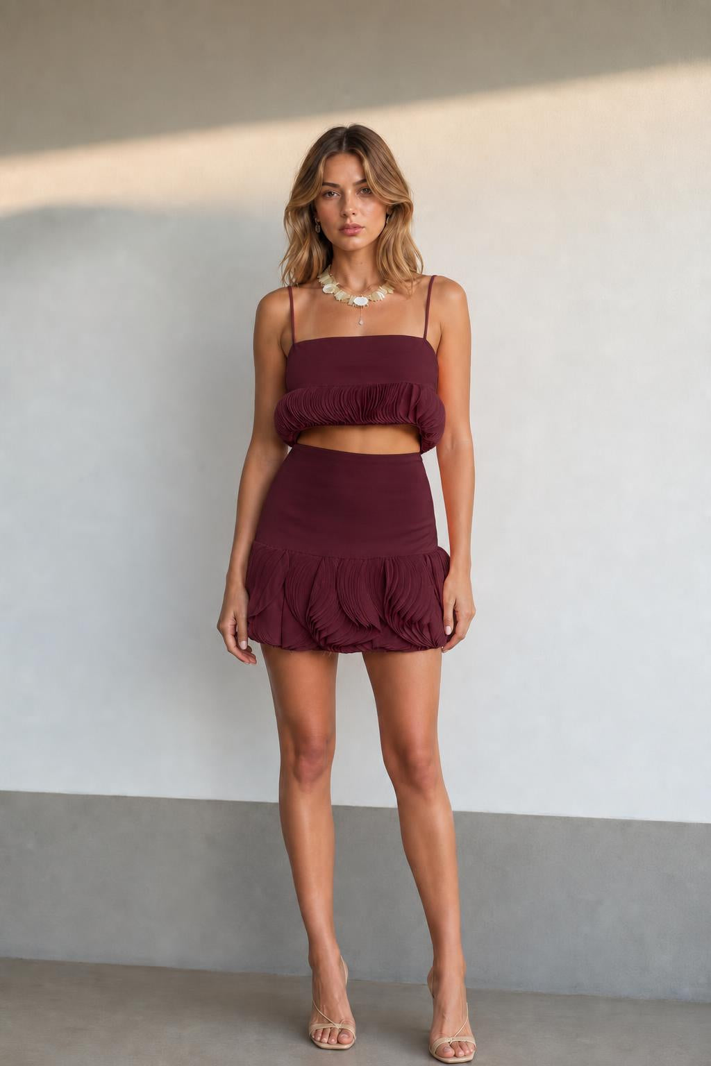 Front view of model wearing burgundy two-piece set