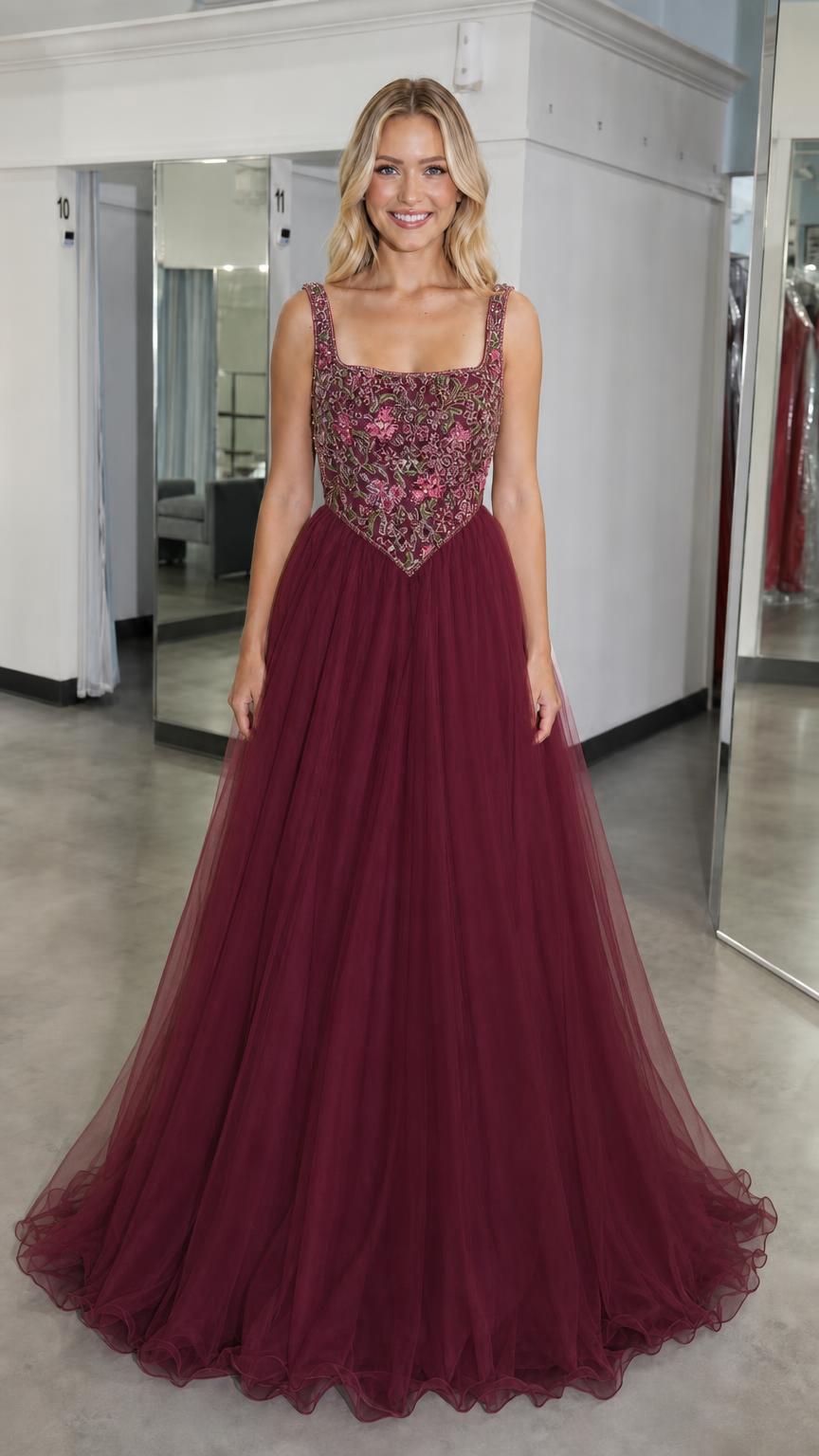 Front view of burgundy embroidered bodice tulle ball gown