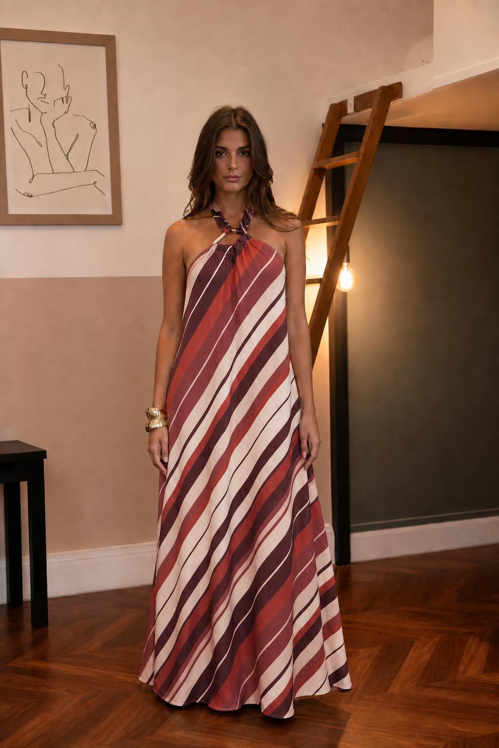 Woman wearing burgundy striped halter maxi dress