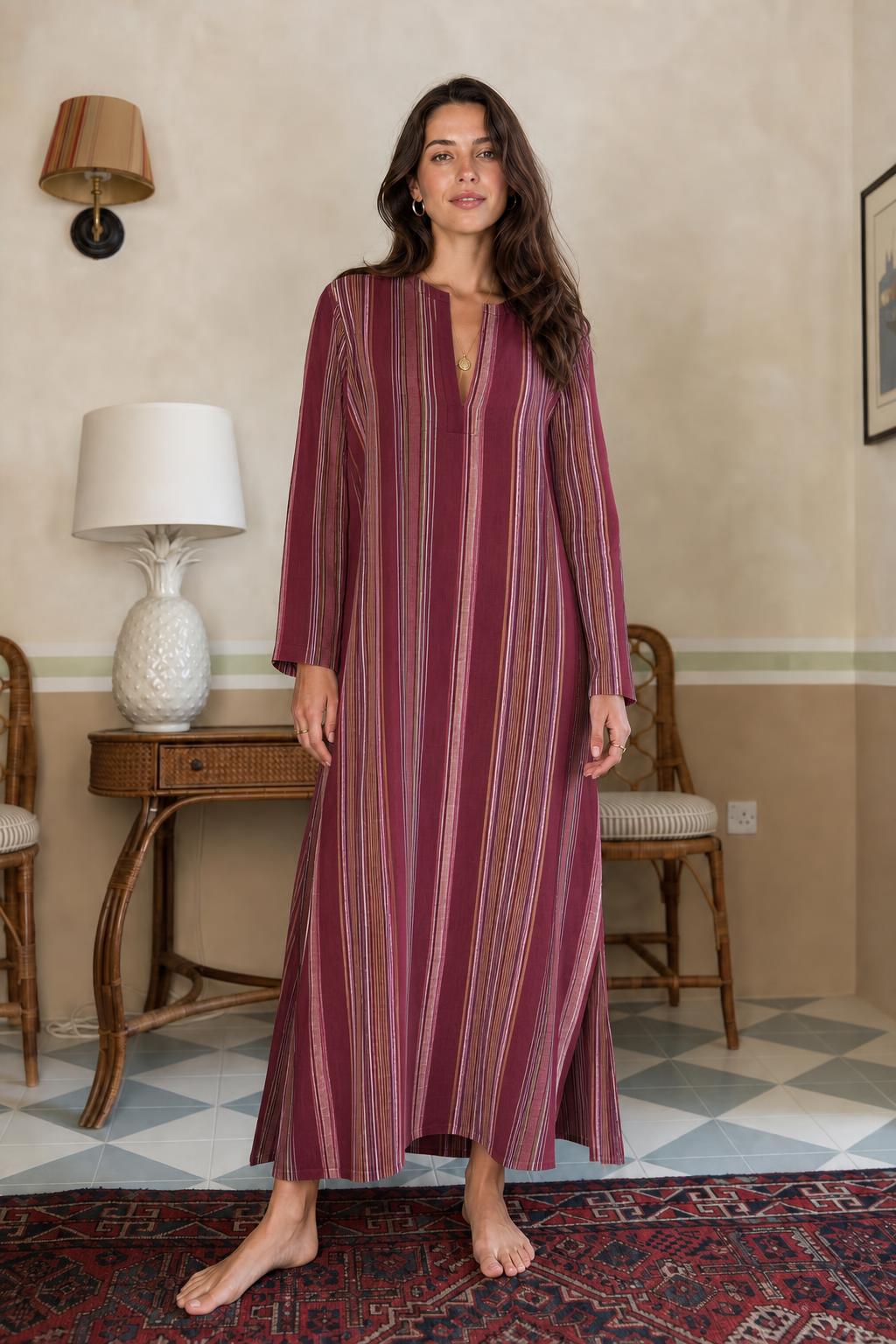 Model wearing burgundy vertical stripe long sleeve maxi dress