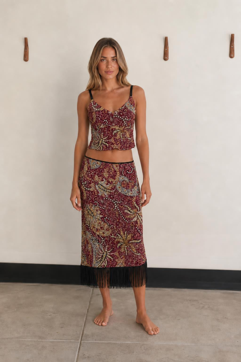 Front view of woman wearing Burgundy Multi paisley crop top and fringe skirt set