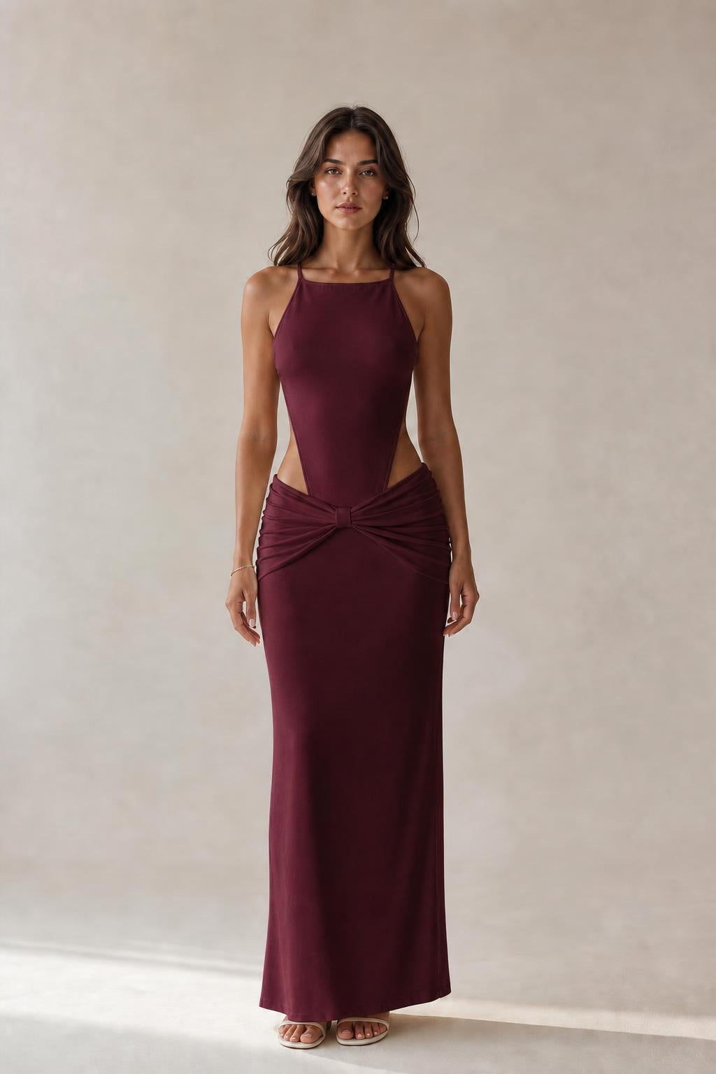 Model wearing burgundy cut-out ruched maxi dress