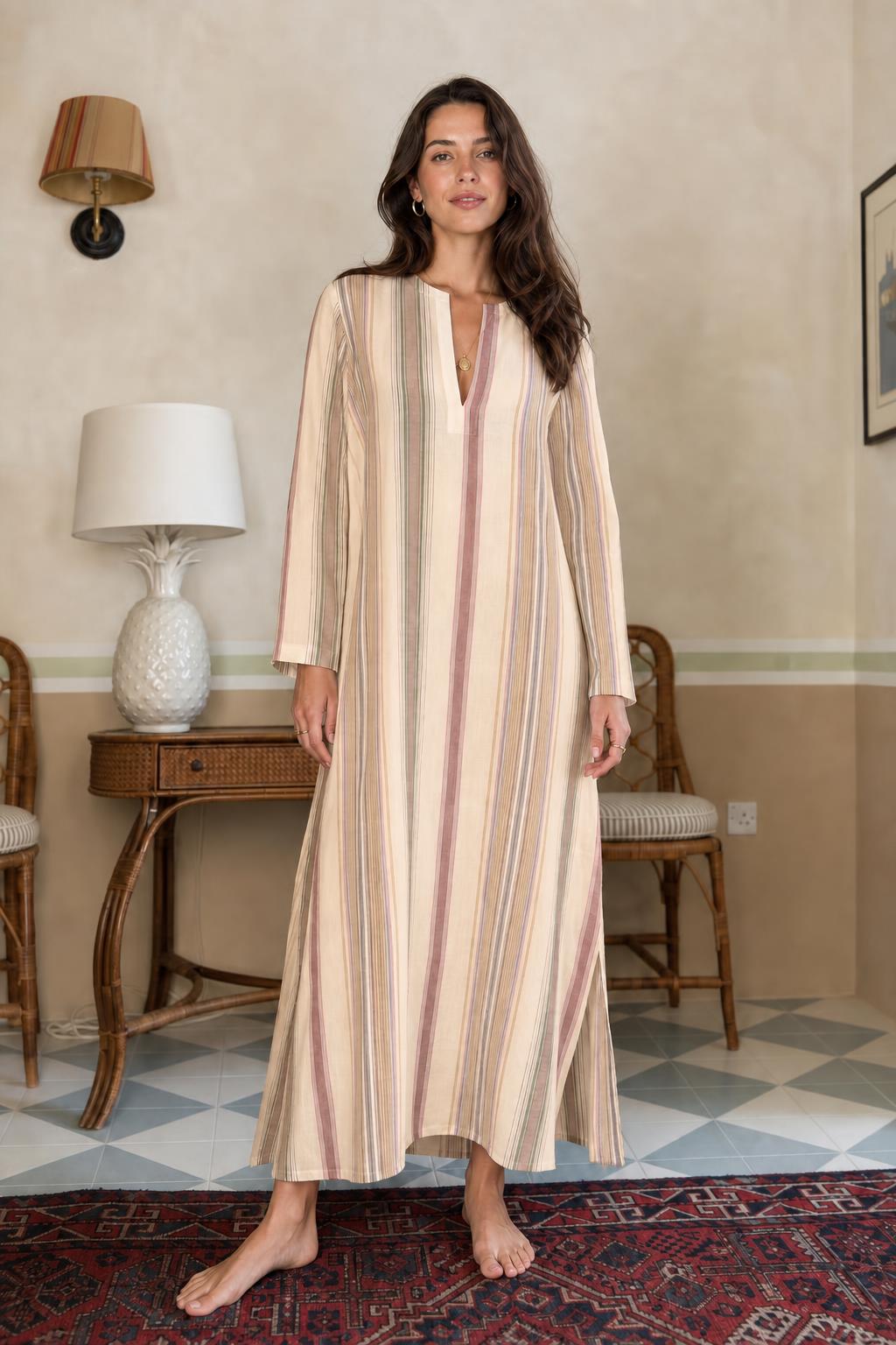 Model wearing beige vertical stripe long sleeve maxi dress