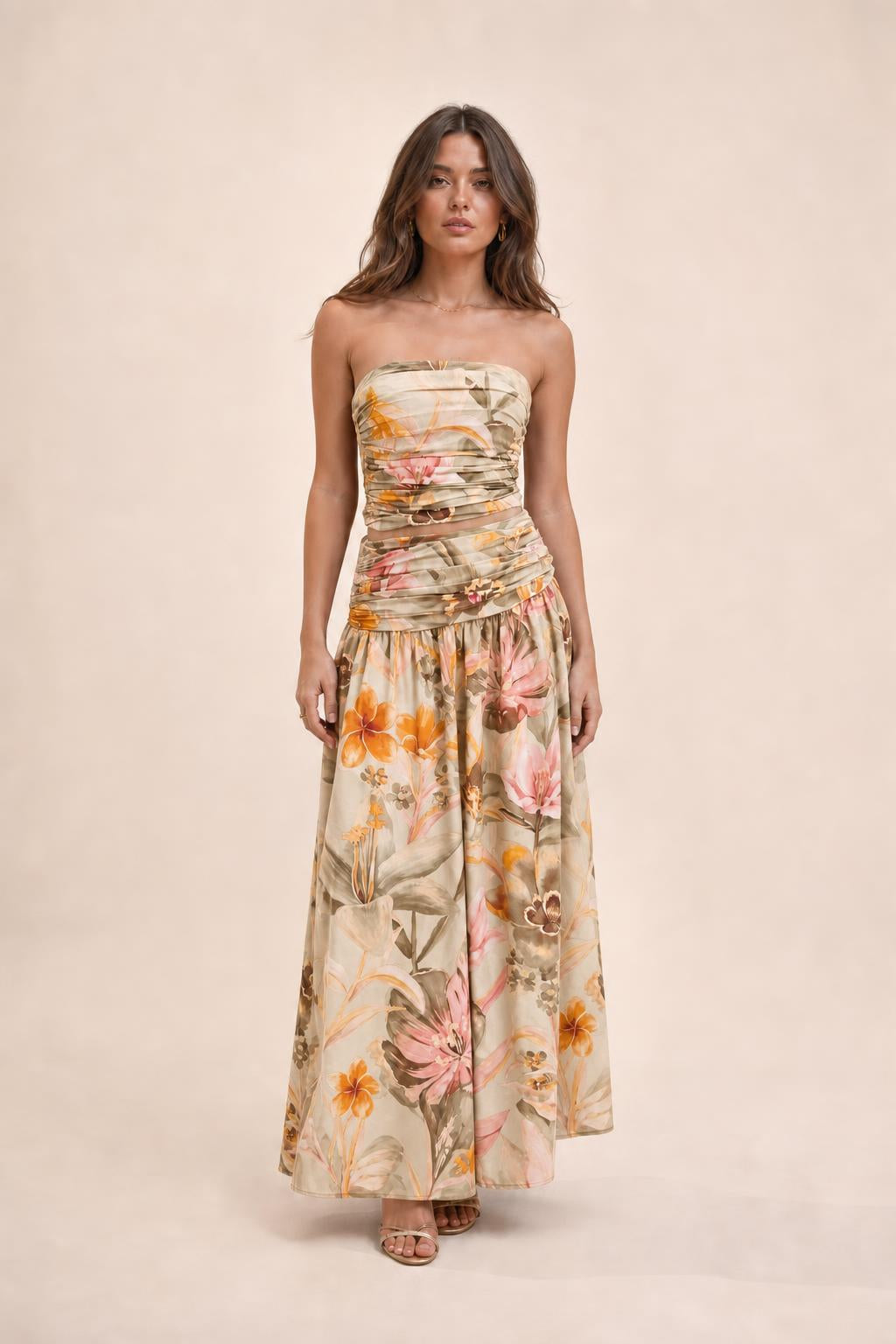 Model wearing beige floral strapless crop top and maxi skirt set
