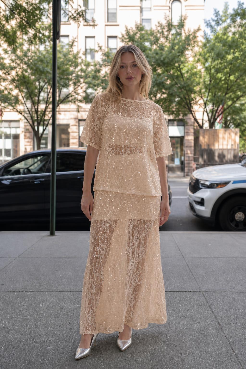 Woman wearing champagne sheer sequin lace two-piece set