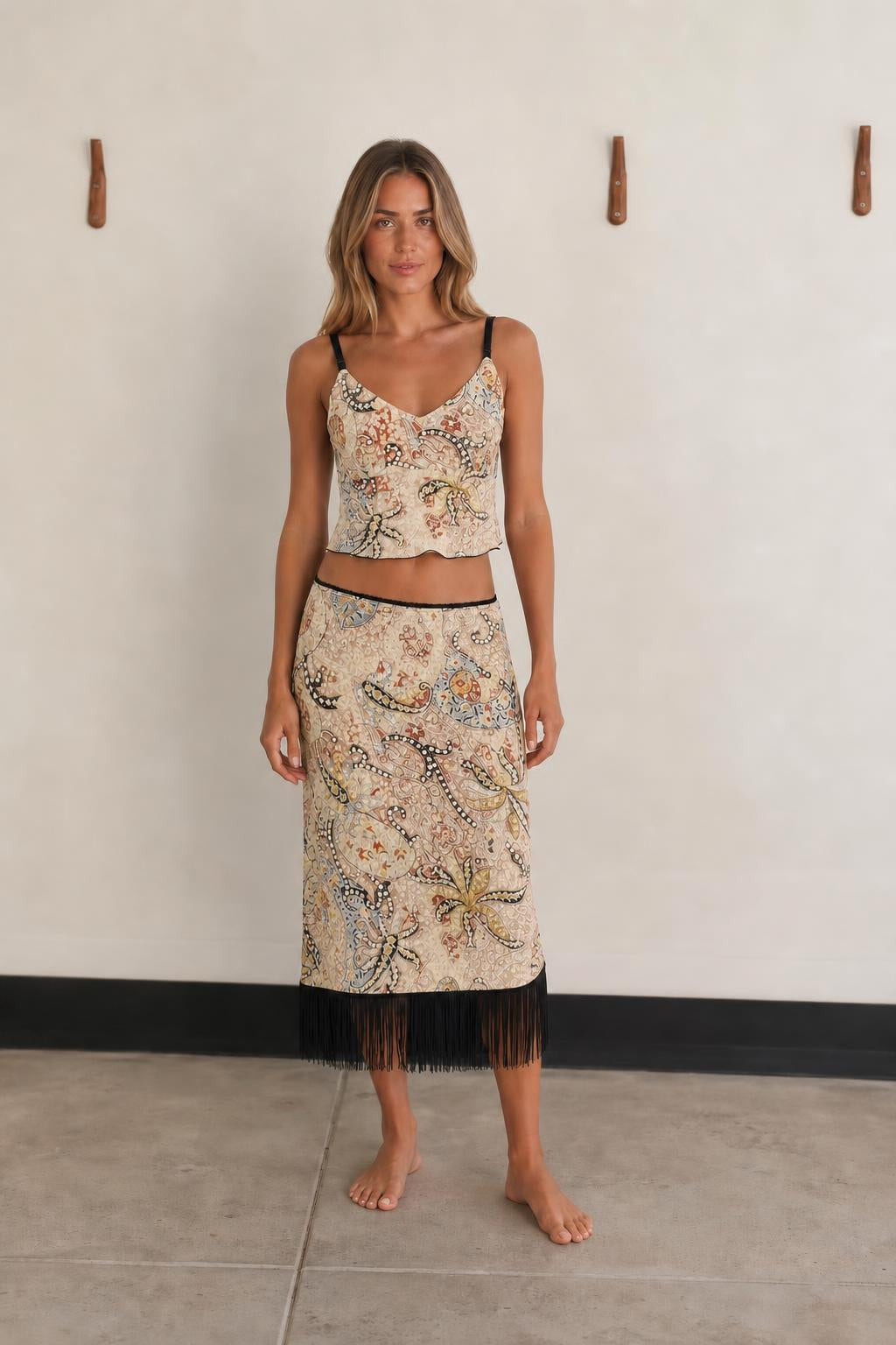 Front view of woman wearing Beige Multi paisley crop top and fringe skirt set
