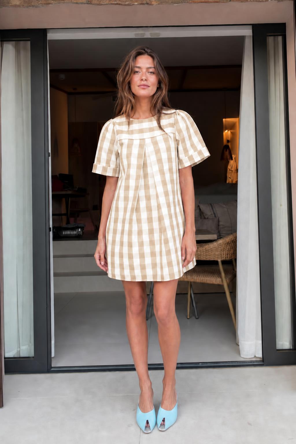 Front view of woman wearing khaki gingham check mini dress