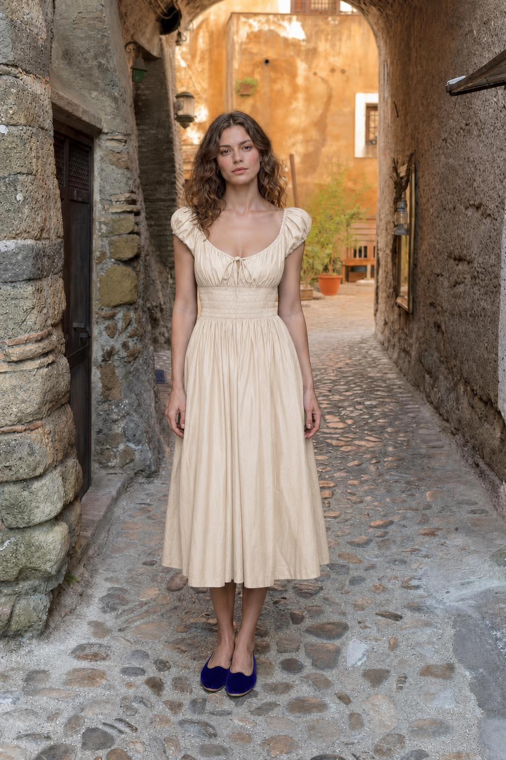 Front view of woman wearing beige smocked midi dress