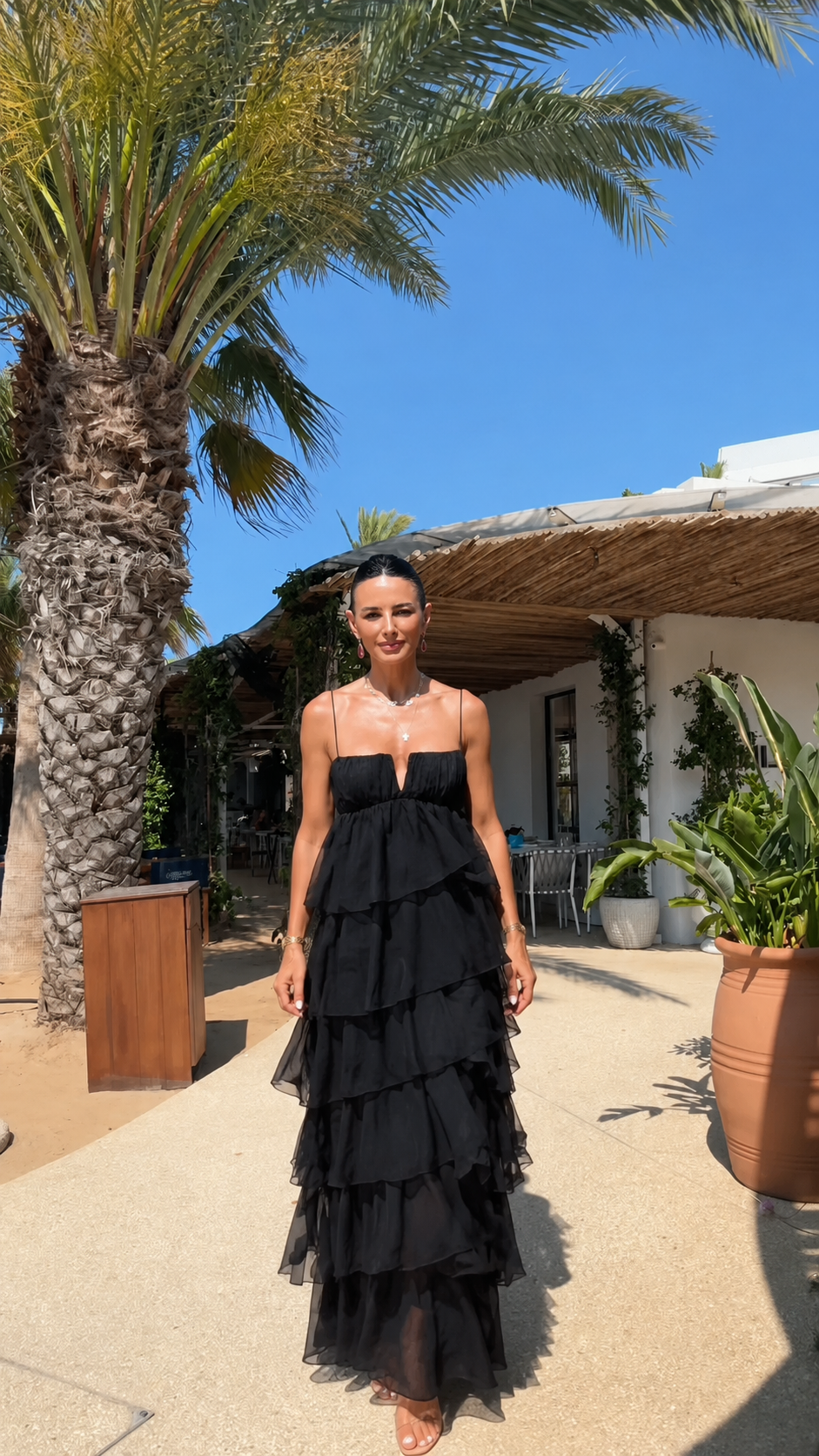 Front view of strapless tiered ruffle maxi dress in black