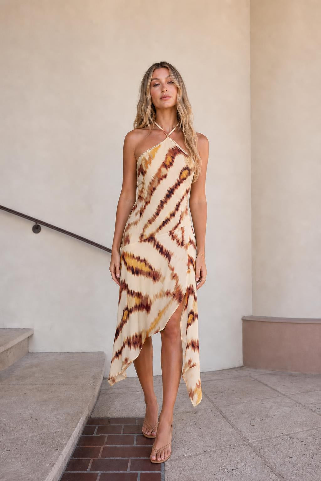 Front view of beige printed halter midi dress