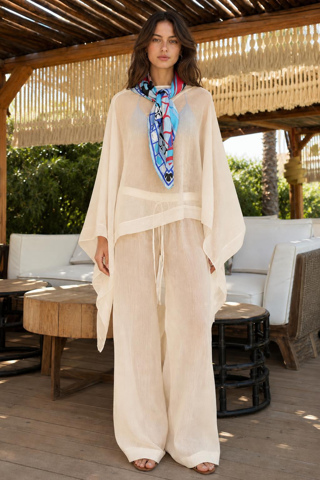 Model wearing beige two-piece kaftan and wide-leg pants set