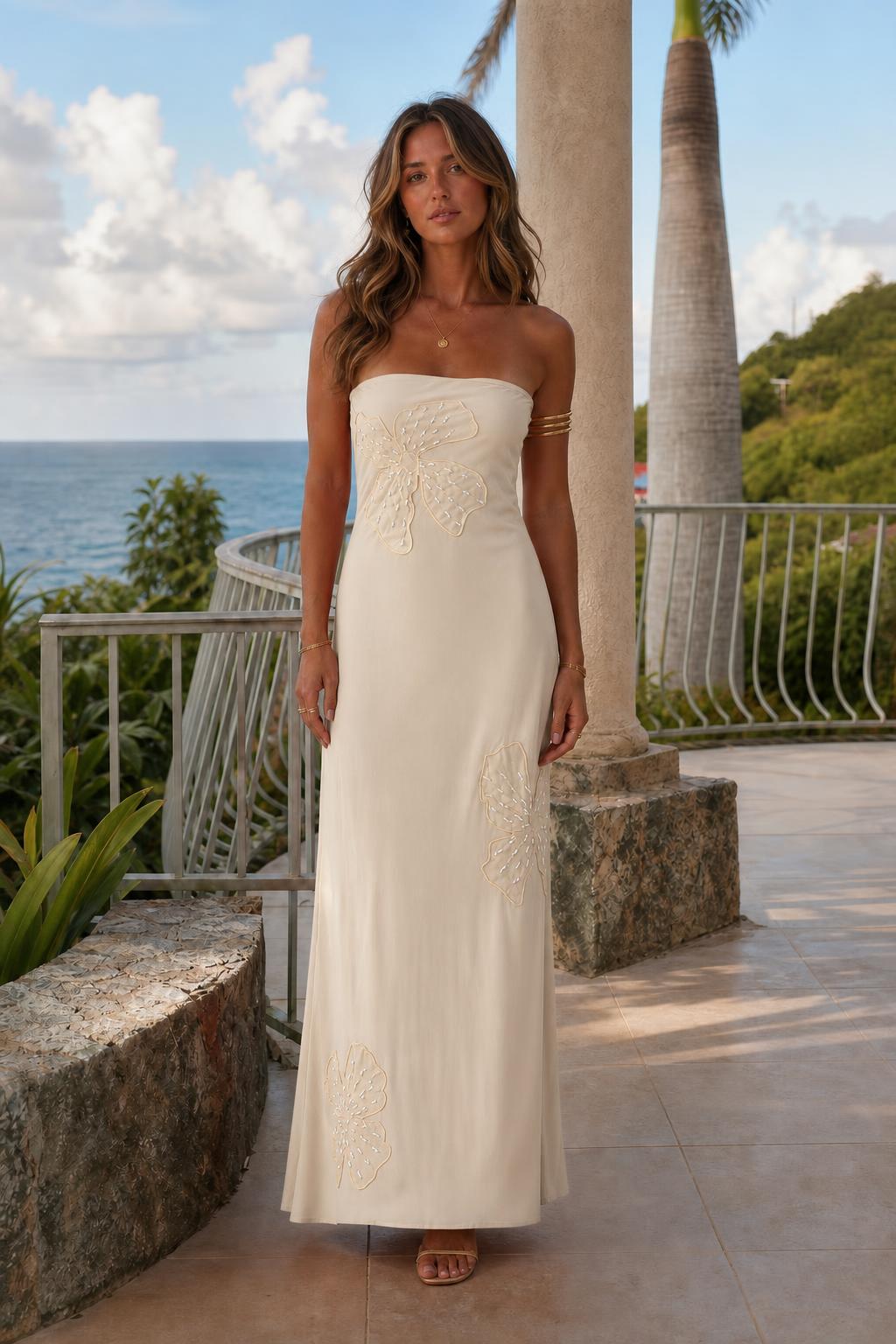 Woman wearing cream white strapless maxi dress outdoors