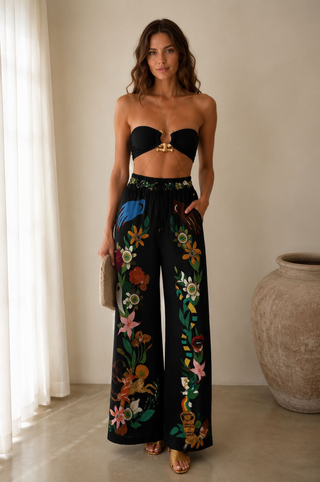 Front view of black bandeau top and black floral wide-leg pants set